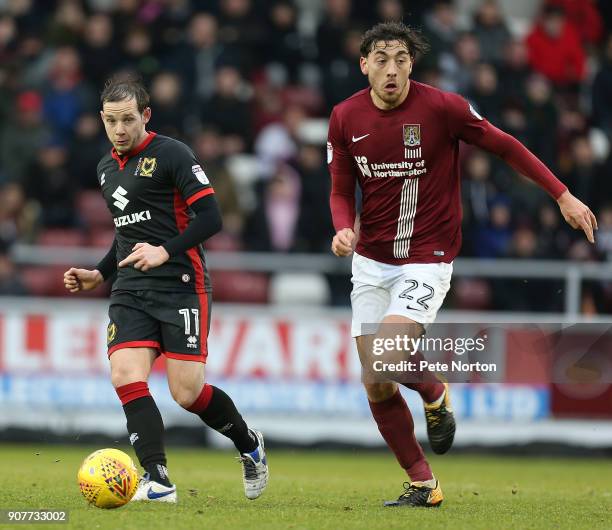 Peter Pawlett of Milton Keynes Dons and Matt Crooks of Northampton Town look to the ball during the Sky Bet League One match between Northampton Town...