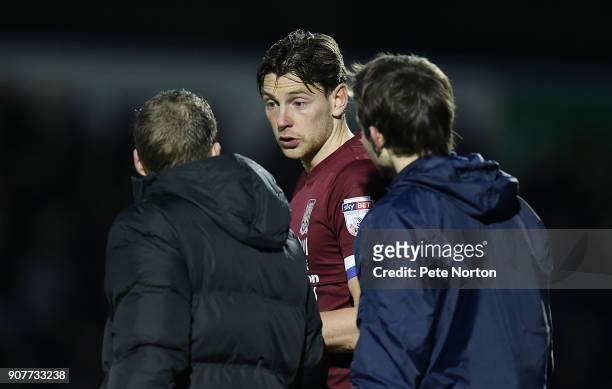 Ash Taylor of Northampton Town talks to 4th Official Christopher Pollard during the Sky Bet League One match between Northampton Town and Milton...