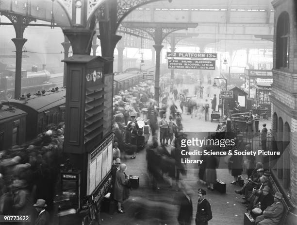 Crowds getting onto a train at Manchester Victoria. The passengers are probably going out for the day as it is a public holiday. The railways put on...