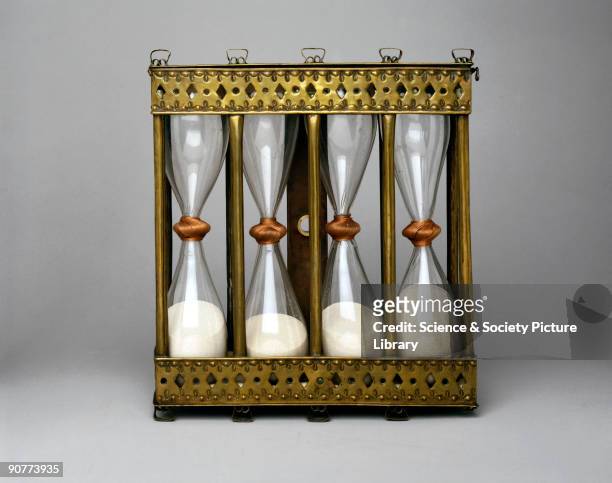 This four-way sand glass in a brass stand was hung on a wall so that the glasses could be inverted as required. They measure intervals of quarter,...