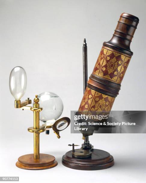 Microscope associated with Robert Hooke , shown with a copy of the illuminating system used. This microscope, among the scientific instruments...