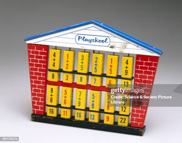 An educational toy with a wooden framework with rotating blocks bearing numbers and symbols to do arithmetic.