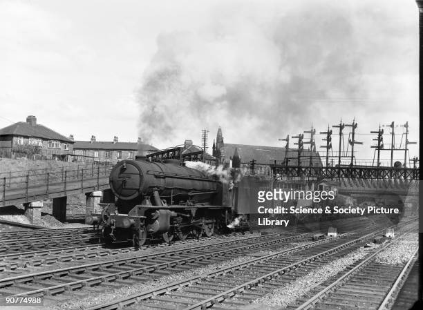Class 2-8-0 locomotive number 90609 with a goods train at Holgate junction, York, by Eric Treacy, 1950. This locomotive is a British Railways...