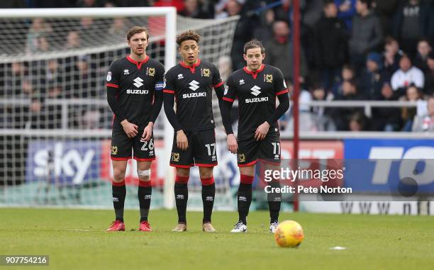 Alex Gibley, Marcus Tavernier and Peter Pawlett of Milton Kynes Dons line up to defend a free kick during the Sky Bet League One match between...