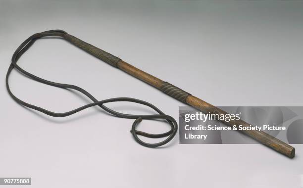 Slave whip made of leather and wood with woven steel wire mounts.