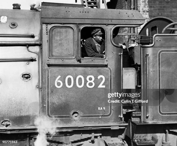 Jamaican-born Wilston Samuel Jackson , the fireman of class A3 4-6-2 No 60082 'Neil Gow', waits for right of way to return to the top shed at King's...