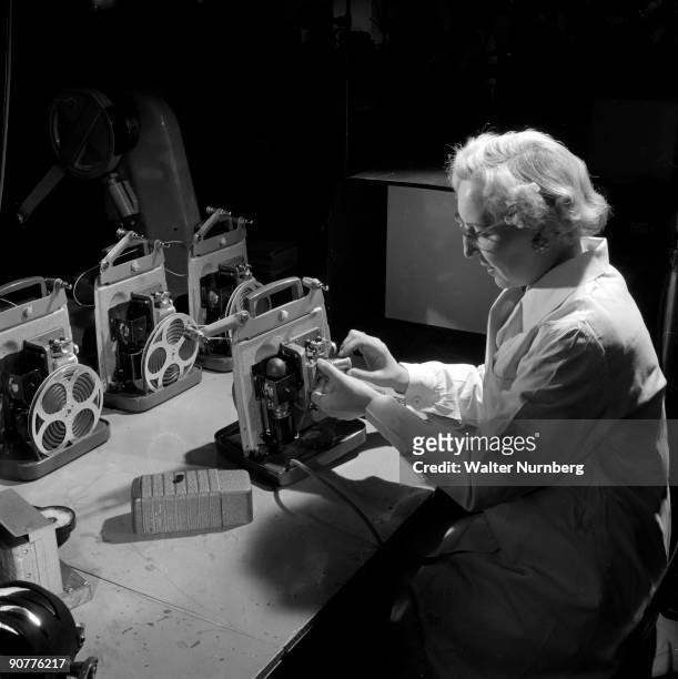 Assembling an 8mm cine projector at the factory of British Acoustic Films. The Surrey based company thrived during the 1950s boom in amateur cine,...