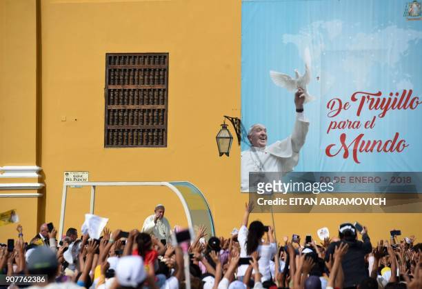 Pope Francis waves at the crowd as he passes in the popemobile through the streets of the Peruvian city of Trujillo, on January 20, 2018. - Pope...