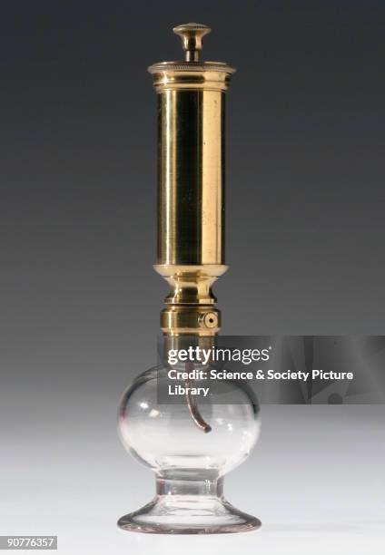 Glass collecting bowl with brass syringe. Breast pumps were used to help women express milk when breast-feeding.