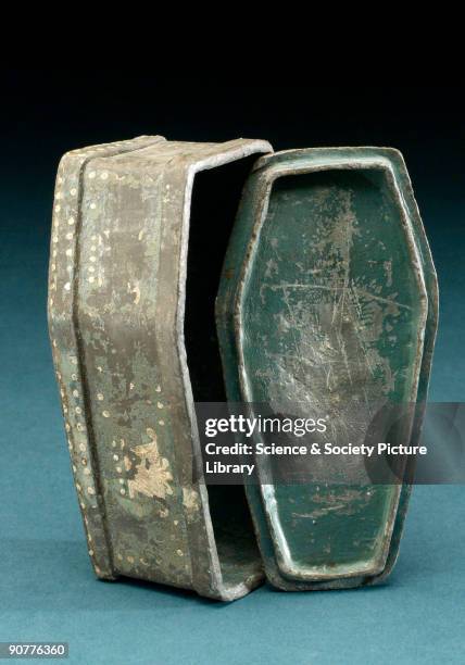 Small jar used for storing pipe tobacco in the form of a coffin with detachable flanged lid. The interior of the jar was originally painted dark...