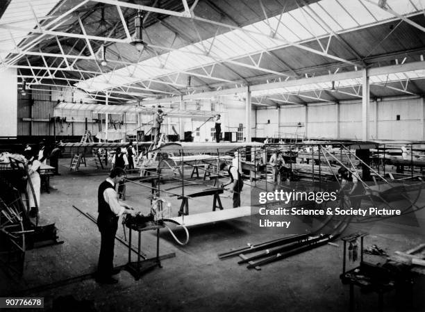 Photograph taken at the Bristol Aeroplane Co Ltd, Bristol, showing workers assembling the wings for two Boxkites. Based on a French biplane called...