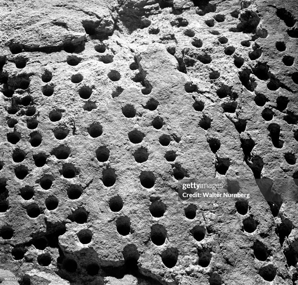 Study of drill holes in a mine rock face ready for breaking up. Holman Brothers.