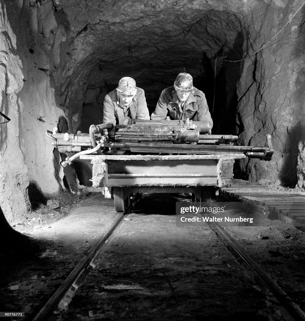 Two miners underground pushing trolley at Holman Brothers, Cambourne, 1948.