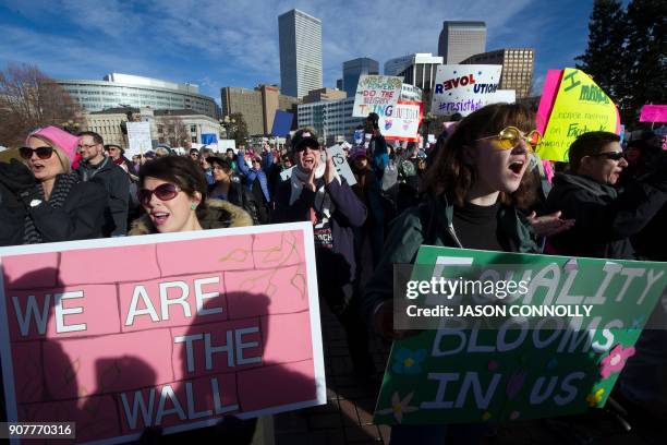 Demonstrators march during the Denver's Women's March in Denver, Colorado on January 20 one year after thousands of supporters marched around the...