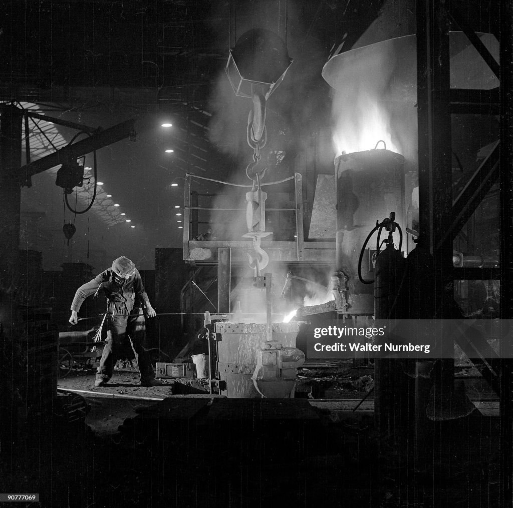 A spectacular image of a foundry worker tending molten iron, Burton, 1953.