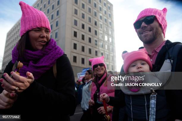 Rachel and Jordan Roth march with their son George during the Denver's Women's March in Denver, Colorado on January 20 one year after thousands of...
