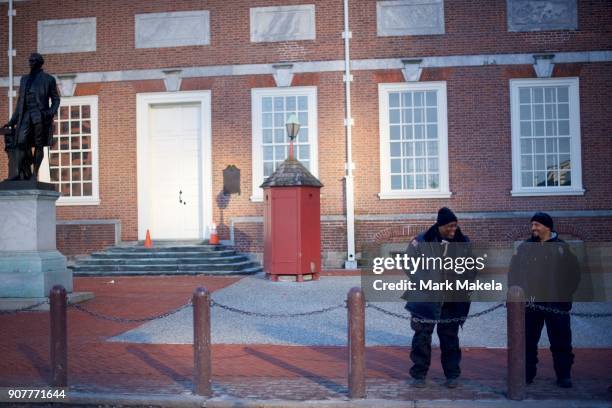 Security officers share a laugh in front of the shuttered Independence Hall after the government shutdown on January 20, 2018 in Philadelphia,...