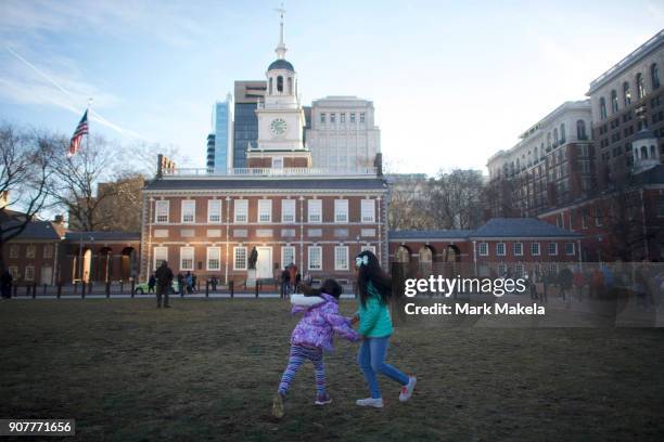 Girls play in front of the shuttered Independence Hall after the government shutdown on January 20, 2018 in Philadelphia, Pennsylvania. As estimated...