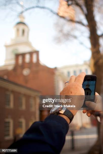 Tourist photographs the shuttered Independence Hall after the government shutdown on January 20, 2018 in Philadelphia, Pennsylvania. As estimated by...