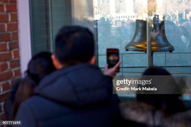 Tourists wait in line to see the Liberty Bell in front of the shuttered Independence Hall after the government shutdown on January 20, 2018 in...