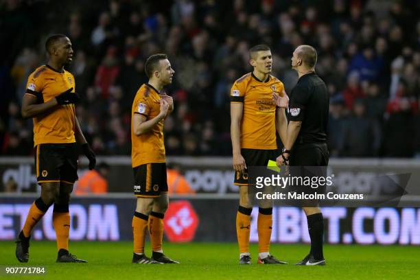 Referee Bobby Madley makes a point to Willy Boly, Diogo Jota and Conor Coady of Wolverhampton Wanderers during the Sky Bet Championship match between...