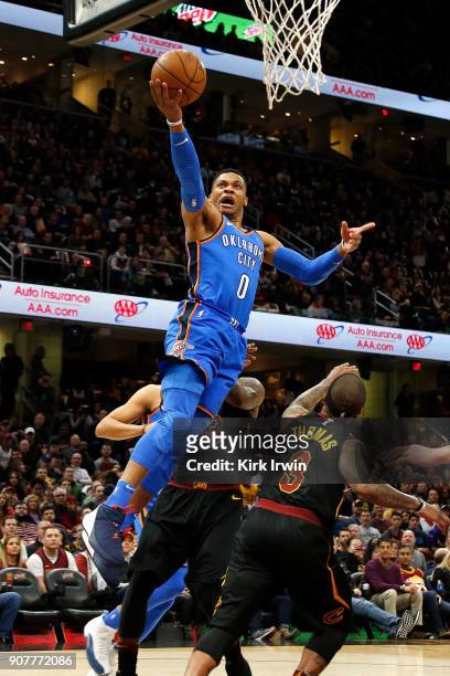 Russell Westbrook of the Oklahoma City Thunder drives past Isaiah Thomas of the Cleveland Cavaliers to score a basket during the first quarter at...