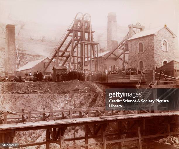 Albumen photographic print showing the pit head, winding gear and coal trucks of a colliery at Ponsy Pool. Miners can be seen assembled around the...