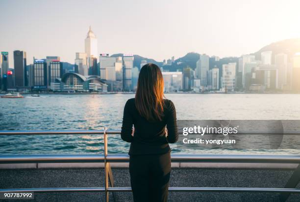 jonge vrouw genieten van het stadsbeeld - brunette woman back stockfoto's en -beelden