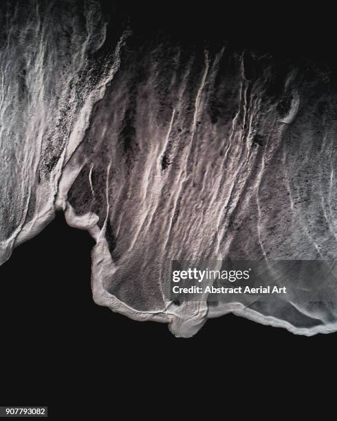 aerial top down of a wave on the black beach in iceland - black sand iceland stock pictures, royalty-free photos & images