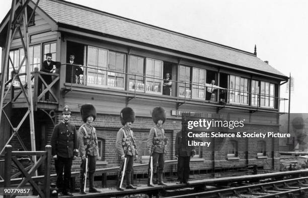 Guardsmen and policemen on sentry duty at Clapham Junction North signal box, London, August 1911. This photograph was taken during a two day strike...