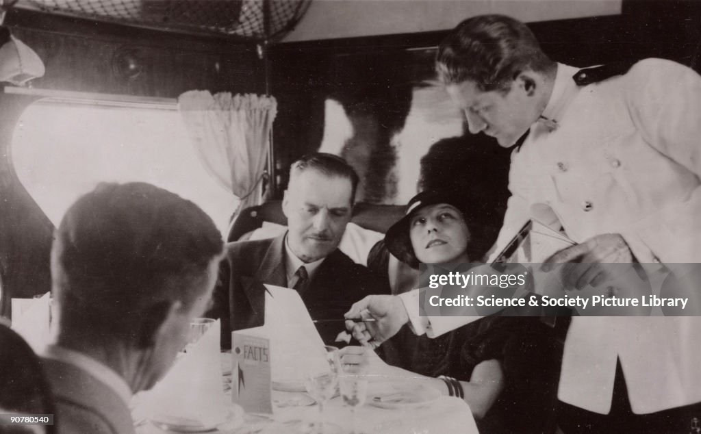 Steward serving lunch in the cabin of an Imperial Airways Scylla, 1934.