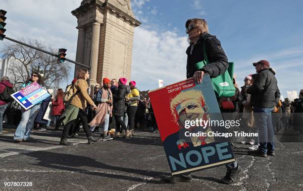 Women holds a poster depicting Donald Trump during the Women's March Chicago on Saturday, Jan. 20, 2018.