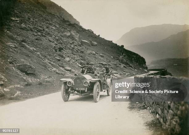 Photograph by H Wade showing a party of four men enjoying a motoring trip in the Welsh mountains. The Nant Francon Pass is on the road through...