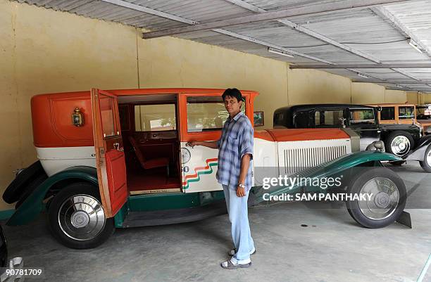 Car Maintenance Supervisor Sunil Shukla poses with a Phantom class Limousine-Rolls Royce of 1926 at 'Auto World' car museum in Kathwada some 20kms....