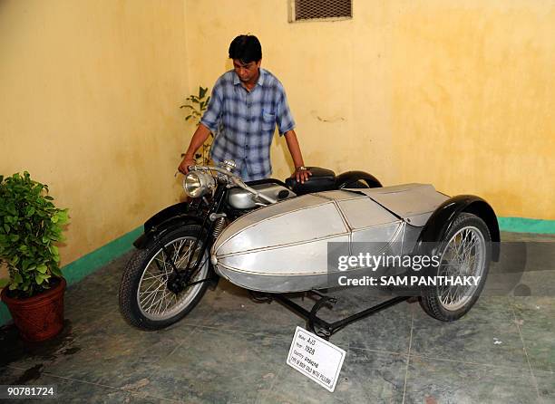 Car Maintenance Supervisor Sunil Shukla looks an antique AJS 1928 motorcycle at 'Auto World' car museum in Kathwada some 20kms. From Ahmedabad on...