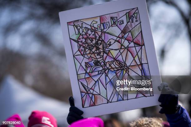 Demonstrators hold signs depicting "Rosie the Riveter" during the second annual Women's March Chicago in Chicago, Illinois, U.S., on Saturday, Jan....