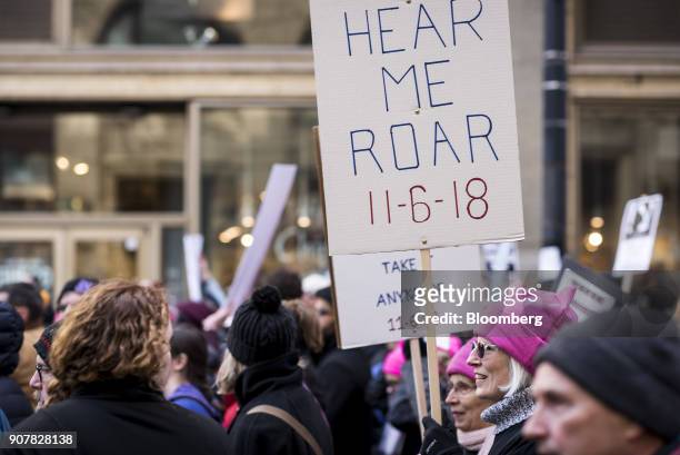 Demonstrators hold signs during the second annual Women's March Chicago in Chicago, Illinois, U.S., on Saturday, Jan. 20, 2018. One year after the...