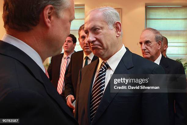 Israeli Prime Minister Benjamin Netanyahu speaks with an unidentified State Department official as he and U.S. Special Envoy George Mitchell head...