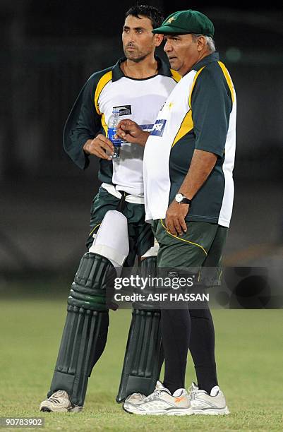 Pakistan cricket team coach Intikhab Alam chats with team captain Younus Khan during a team training session late September 14 in preparation for...