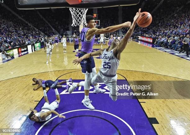 Alex Robinson of the TCU Horned Frogs has his shot blocked by Mike McGuirl of the Kansas State Wildcats during the second half on January 20, 2018 at...