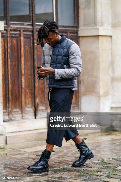 Deandre Hopkins wears a puffer coat, cropped pants, outside Thom Browne, during Paris Fashion Week - Menswear Fall Winter 2018-2019, on January 20,...