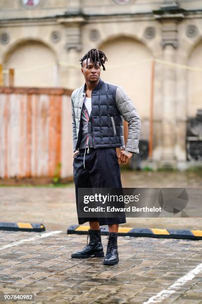 Deandre Hopkins wears a puffer coat, cropped pants, outside Thom Browne, during Paris Fashion Week - Menswear Fall Winter 2018-2019, on January 20,...