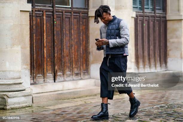 Deandre Hopkins wears a puffer coat, cropped pants, outside Thom Browne, during Paris Fashion Week - Menswear Fall Winter 2018-2019, on January 20,...