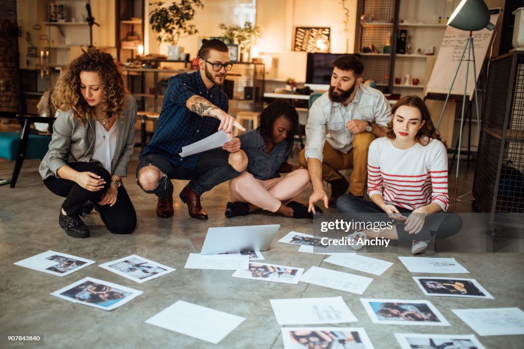 Designers Planning Layout On Floor Of Modern Office