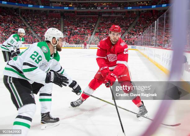 Dominic Turgeon of the Detroit Red Wings battles in the corner with Greg Pateryn of the Dallas Stars during an NHL game at Little Caesars Arena on...