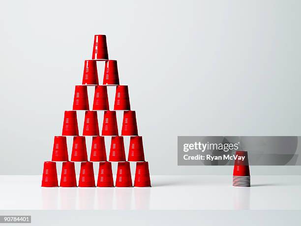 pyramid and stack of red plastic cups. - plastic cup stock pictures, royalty-free photos & images