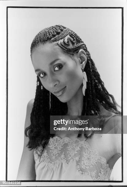 Portrait of American fashion model and actress Beverly Johnson, with braided hair, as she poses in front of a white background, New York, 1970s.