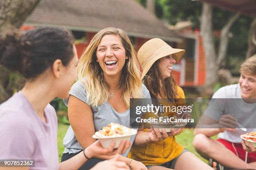 Friends eating smoothie bowls topped with fresh tropical fruit Friends eating smoothie bowls topped with fresh tropical fruit