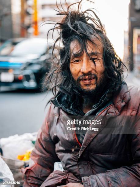 homeless man in tokyo japan - homeless man stock pictures, royalty-free photos & images