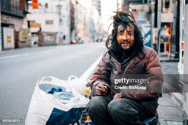 homeless man in tokyo japan - homeless man stock pictures, royalty-free photos & images